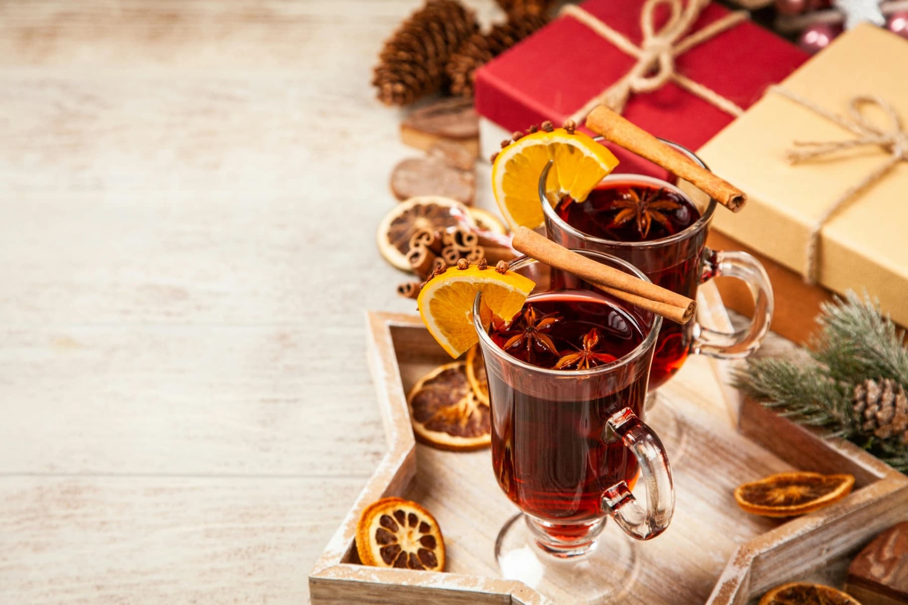 Deux verres de vin chaud avec de la cannelle et du citron.
